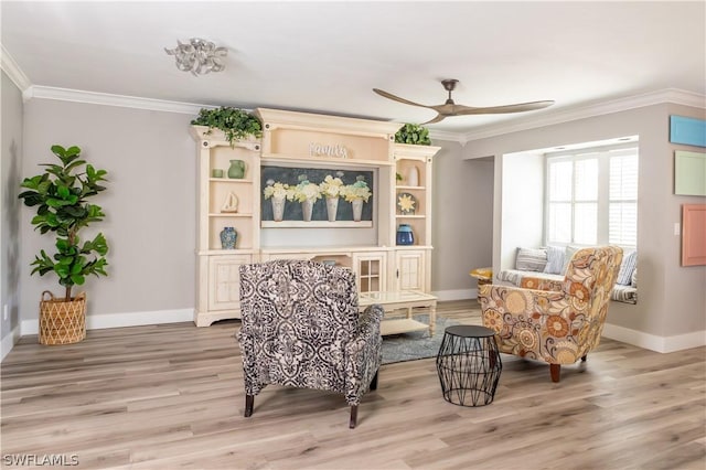 living area featuring light hardwood / wood-style flooring, ceiling fan, and ornamental molding