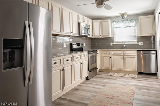 kitchen featuring appliances with stainless steel finishes, ceiling fan, cream cabinets, and sink