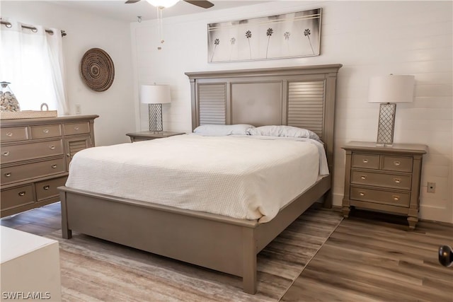 bedroom with wood-type flooring and ceiling fan