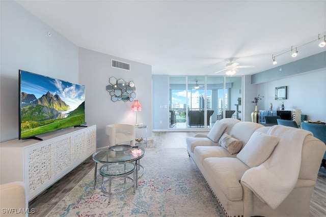 living room with hardwood / wood-style flooring and ceiling fan