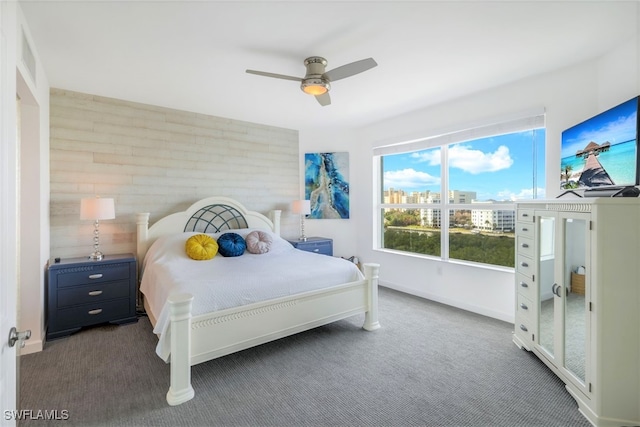 bedroom featuring dark colored carpet and ceiling fan