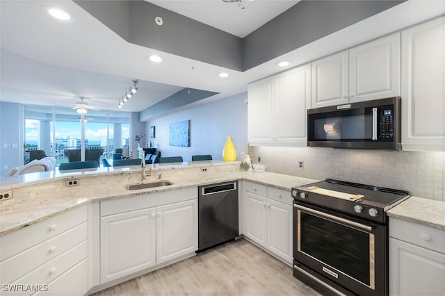 kitchen featuring backsplash, sink, appliances with stainless steel finishes, and white cabinets