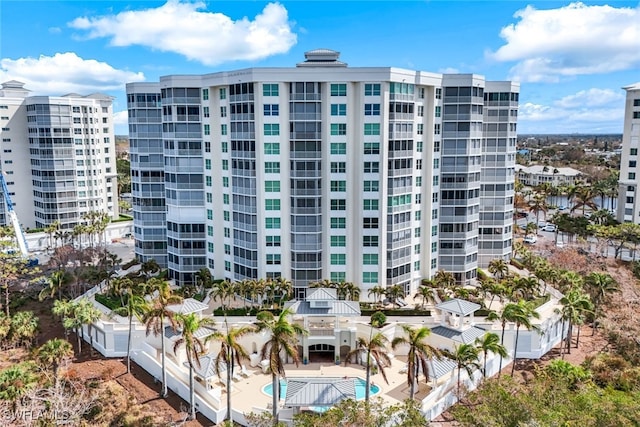 view of building exterior featuring a community pool