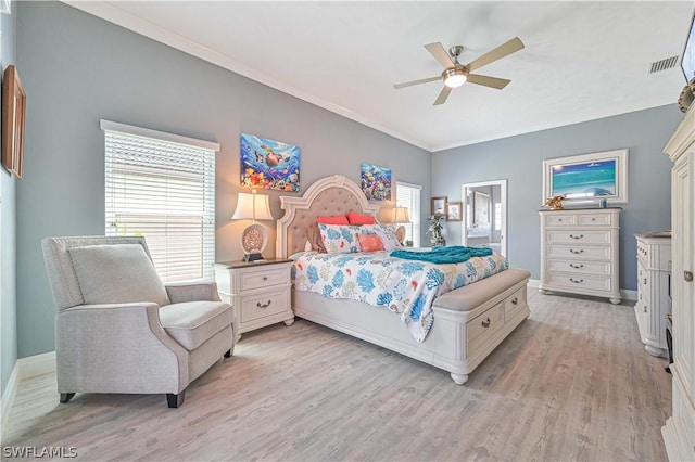 bedroom with light wood-style floors, baseboards, multiple windows, and visible vents