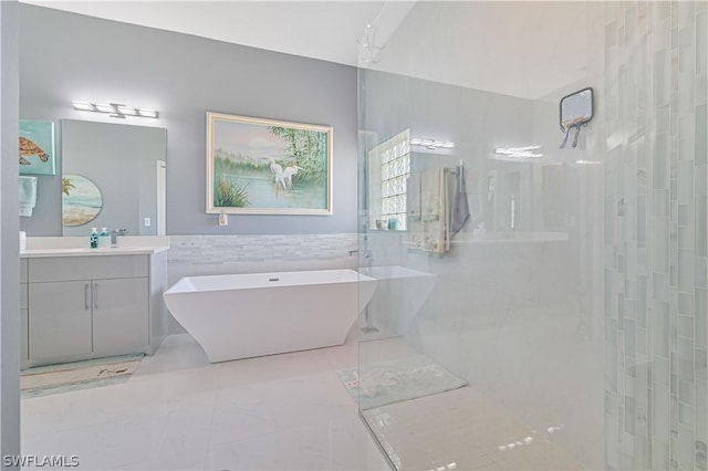 full bathroom featuring a wainscoted wall, vanity, tile walls, a soaking tub, and walk in shower