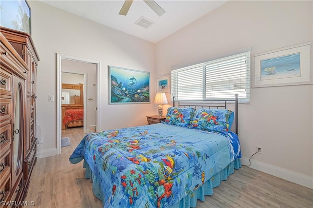 bedroom with a ceiling fan, wood finished floors, visible vents, and baseboards