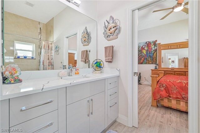 full bath with a ceiling fan, visible vents, vanity, and wood finished floors