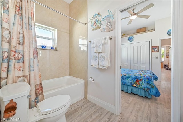 bathroom featuring shower / bath combo, baseboards, a ceiling fan, toilet, and wood finished floors