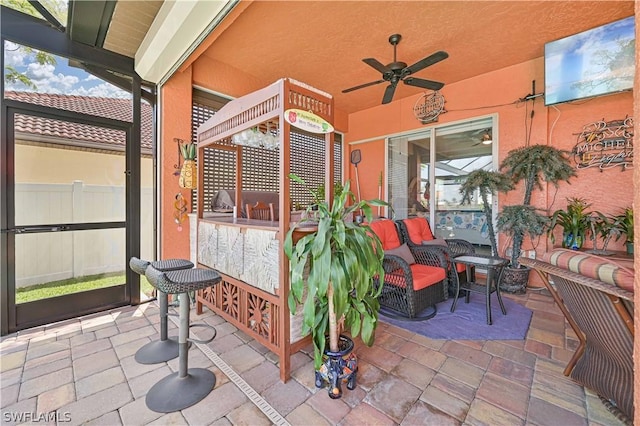 view of patio featuring ceiling fan, outdoor lounge area, and fence