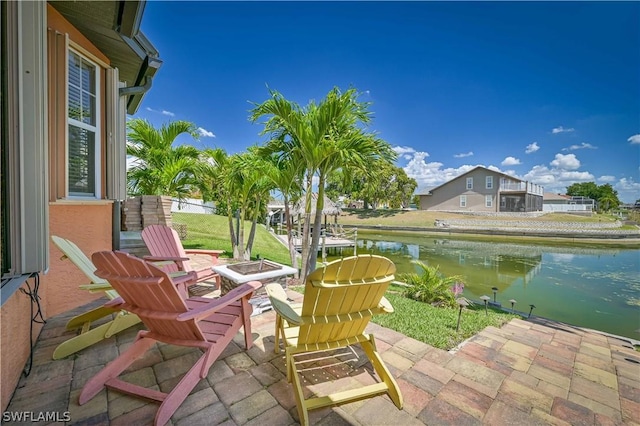 view of patio featuring a water view and a fire pit