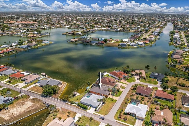 drone / aerial view featuring a water view and a residential view