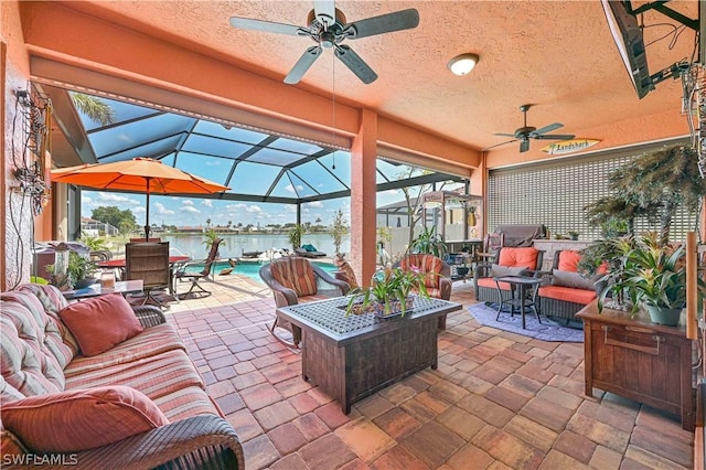 view of patio featuring ceiling fan, a lanai, outdoor lounge area, a water view, and an outdoor pool