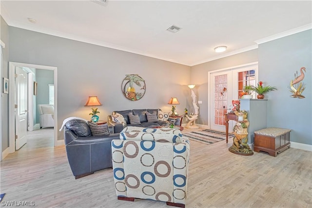 living area with ornamental molding, french doors, visible vents, and wood finished floors