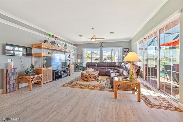 living area featuring ceiling fan, wood finished floors, visible vents, and crown molding