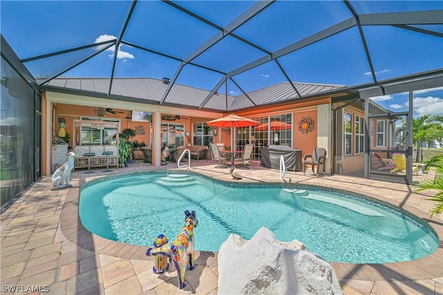 outdoor pool featuring a patio area, a lanai, and a ceiling fan