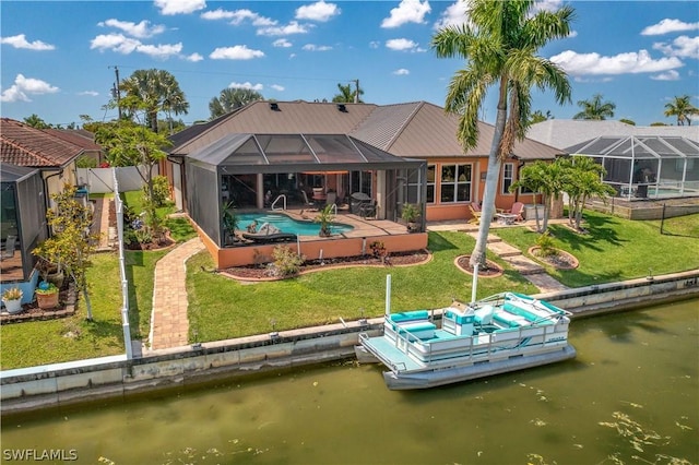 back of property with a yard, a lanai, a water view, and a patio