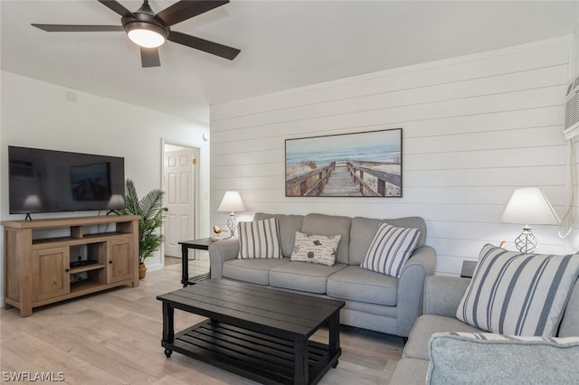 living room with light hardwood / wood-style floors and ceiling fan