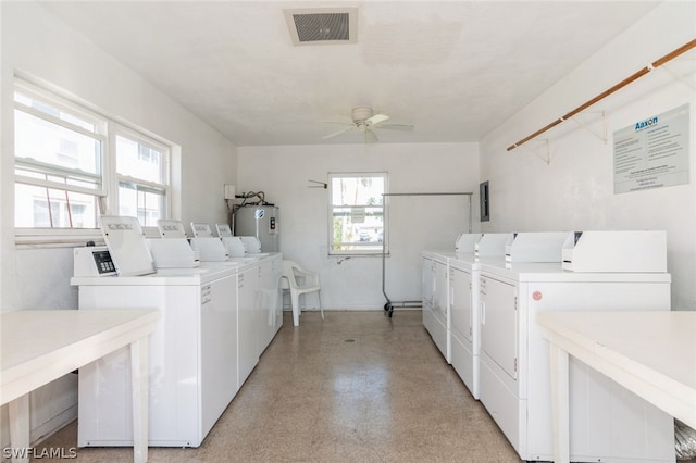 laundry area with ceiling fan, a wealth of natural light, water heater, and washer and clothes dryer