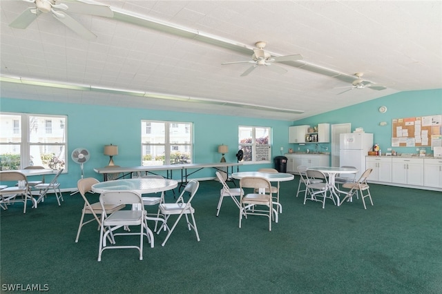 carpeted dining room with ceiling fan