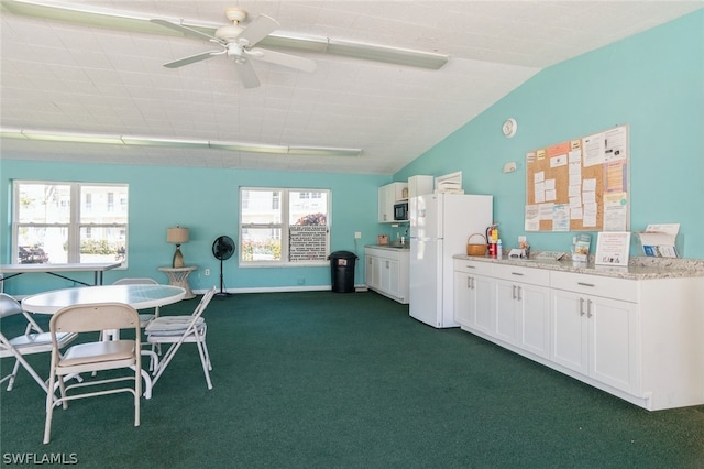 carpeted dining area with a wealth of natural light and ceiling fan