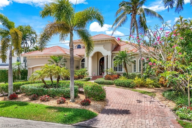 mediterranean / spanish-style home with a garage