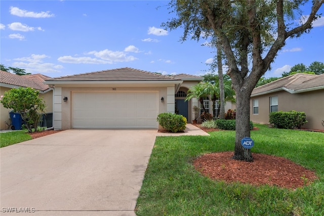 view of front of house featuring a front lawn and a garage