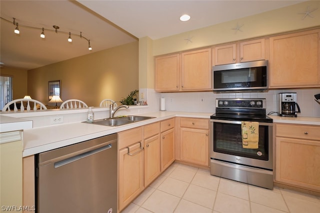 kitchen featuring sink, appliances with stainless steel finishes, backsplash, and light tile flooring