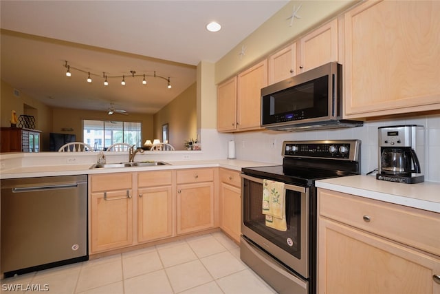 kitchen featuring light brown cabinets, stainless steel appliances, ceiling fan, and sink