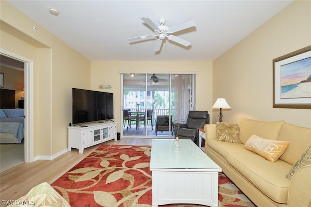 living room with ceiling fan and hardwood / wood-style floors