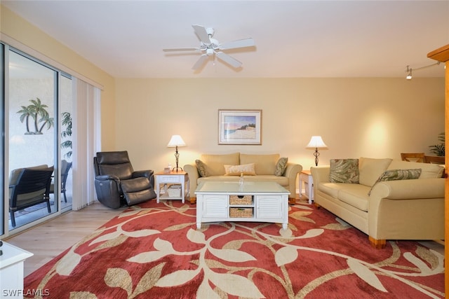 living room featuring ceiling fan and hardwood / wood-style floors