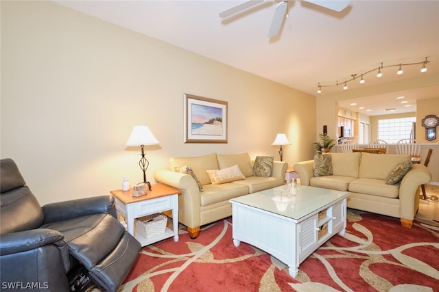 living room featuring carpet floors, ceiling fan, and track lighting