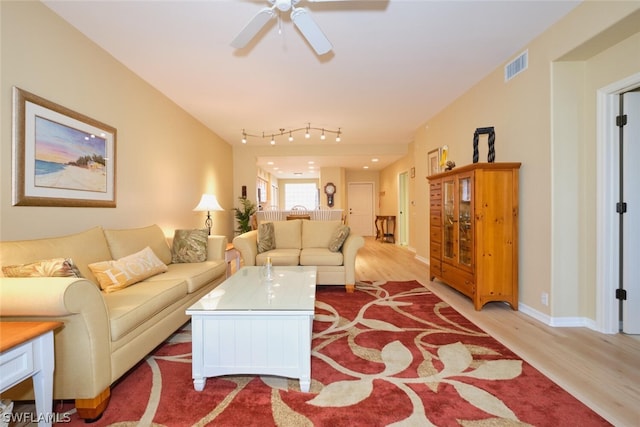 living room featuring ceiling fan, light hardwood / wood-style floors, and track lighting