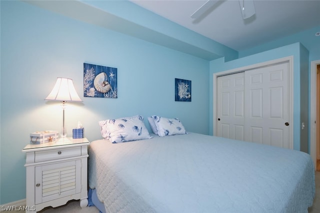 bedroom featuring a closet, ceiling fan, and carpet