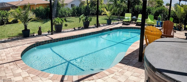 view of swimming pool with a lawn and a patio