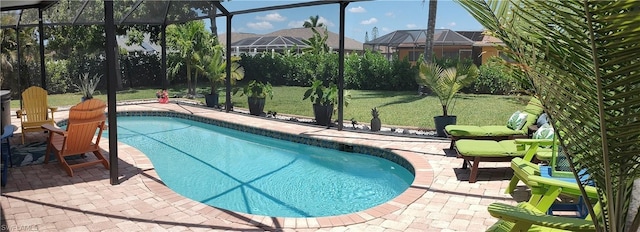 view of pool featuring a patio, a lanai, and a yard