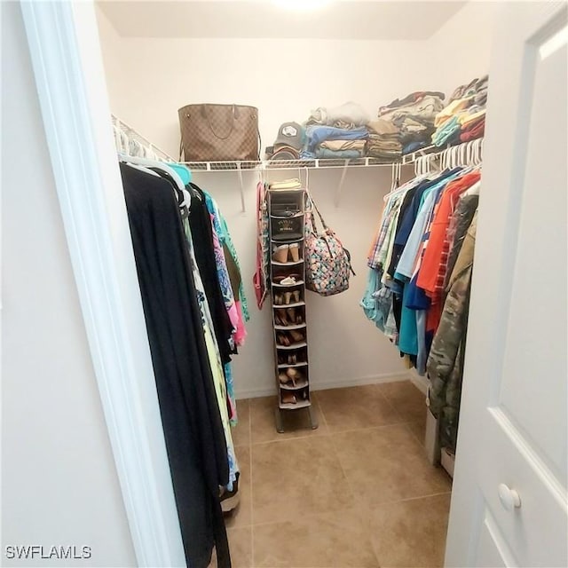 spacious closet featuring light tile patterned flooring