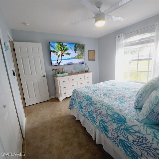 tiled bedroom featuring a closet and ceiling fan