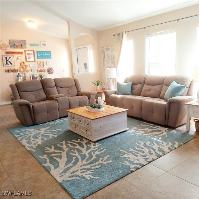 tiled living room featuring lofted ceiling