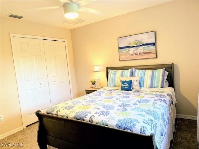 bedroom featuring tile patterned floors, ceiling fan, and a closet