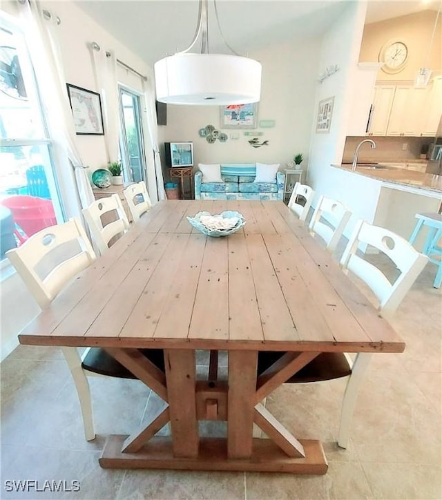 unfurnished dining area featuring sink and light tile patterned floors