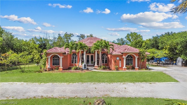 mediterranean / spanish-style home with a front yard