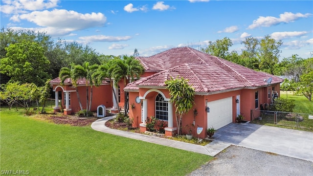 mediterranean / spanish house featuring a front yard and a garage