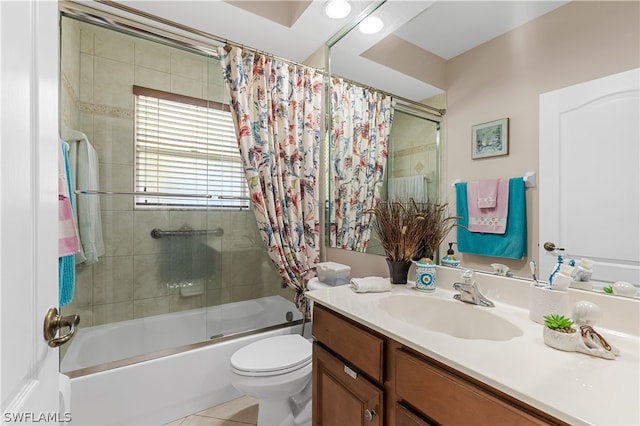 full bathroom featuring tile floors, shower / tub combo, vanity with extensive cabinet space, and toilet