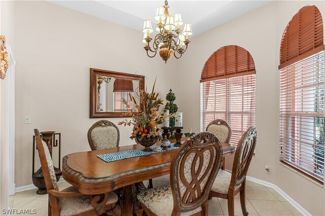 tiled dining space with a chandelier and a wealth of natural light