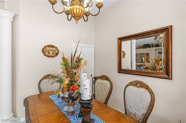 dining space featuring ornate columns and a notable chandelier