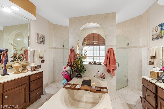 bathroom with vanity, tile walls, and plus walk in shower