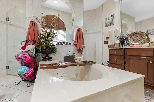 bathroom featuring tile walls, vanity, tile floors, and a bath