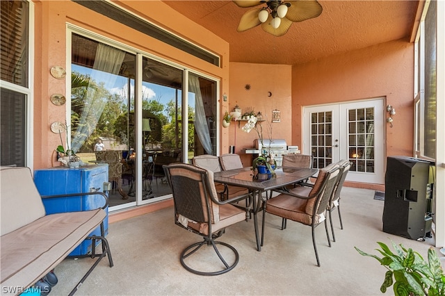 sunroom featuring french doors and ceiling fan