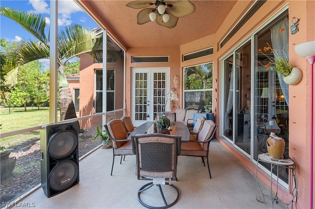 sunroom / solarium featuring french doors and ceiling fan