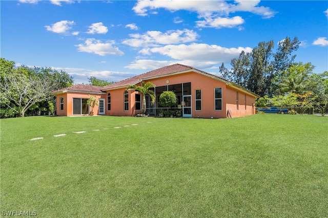 back of property featuring a yard